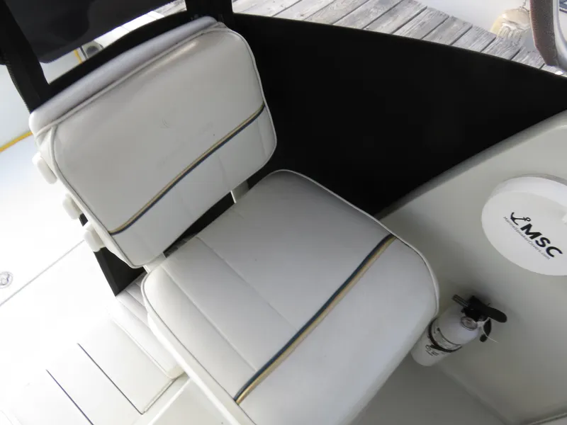 Slide: The Image of White cushioned seat on 1999 Stamas 250 Express boat, featuring sleek design and comfort. - 13
