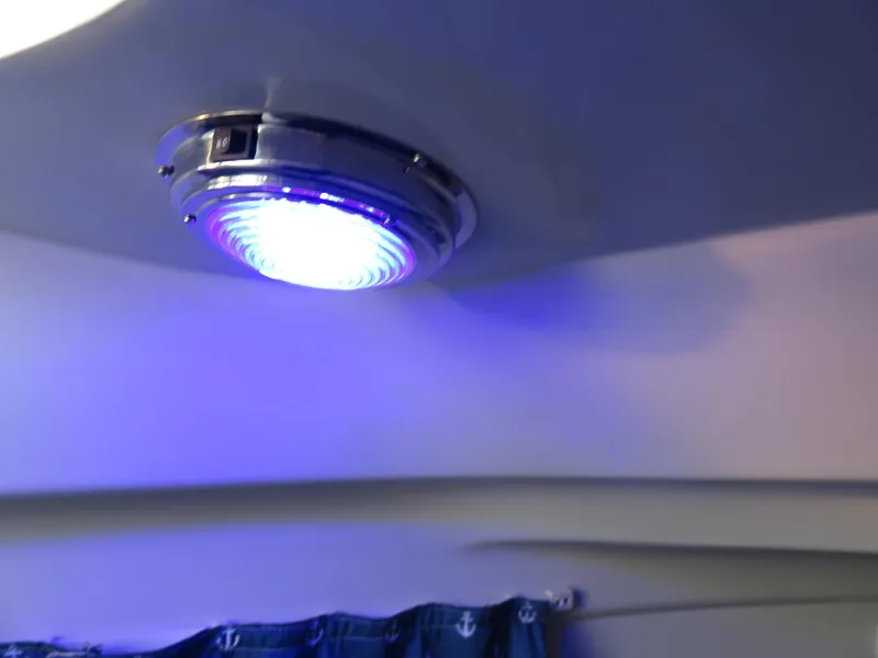 Slide: The Image of Ceiling light with blue glow inside 1999 Stamas 250 Express boat cabin. - 14
