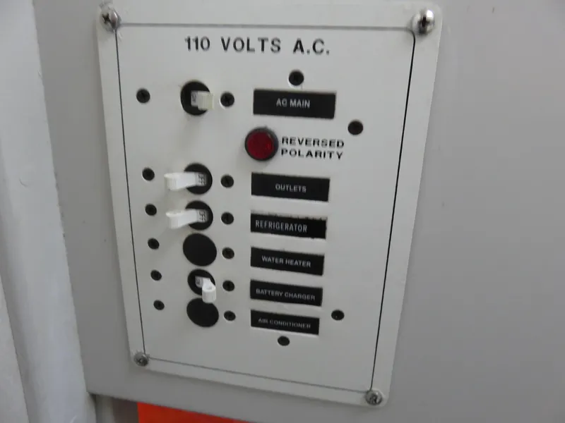 Slide: The Image of Electrical panel on a 1999 Stamas 250 Express boat, showing 110 volts A.C. controls. - 15