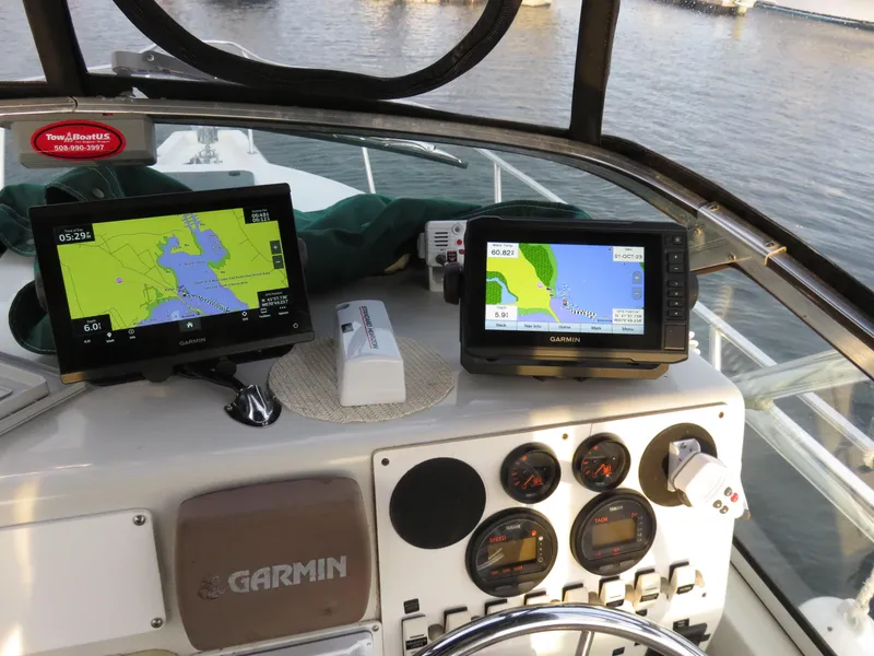 Slide: The Image of 1999 Stamas 250 Express boat dashboard with Garmin navigation systems and gauges. - 16