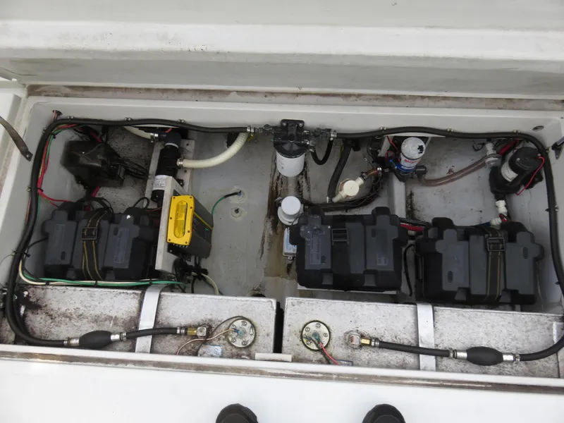 Slide: The Image of 1999 Stamas 250 Express boat battery compartment with wiring and components. - 18