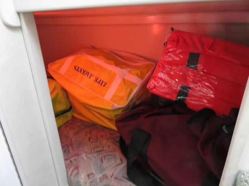 Slide: The Image of Storage compartment with life jackets on a 1999 Stamas 250 Express boat. - 23