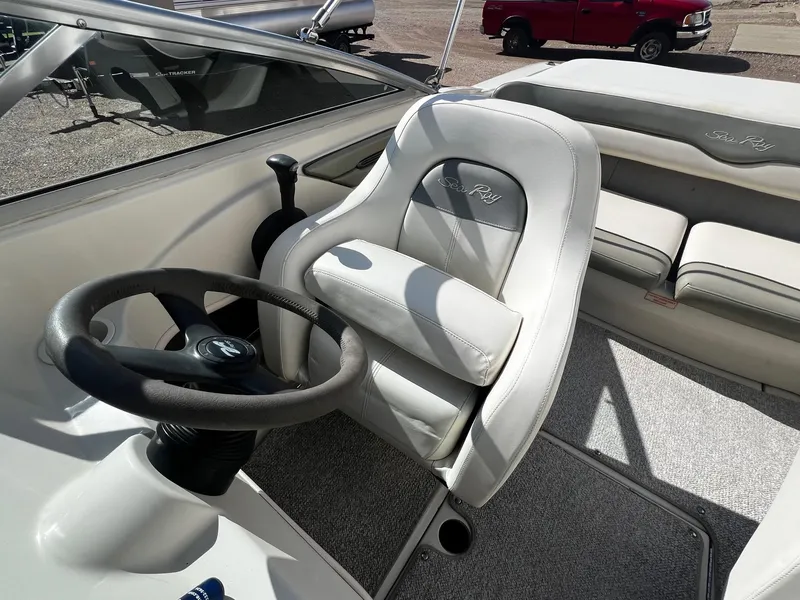 Slide: The Image of 2005 Sea Ray 200 Sport boat interior with steering wheel and seating. - 10