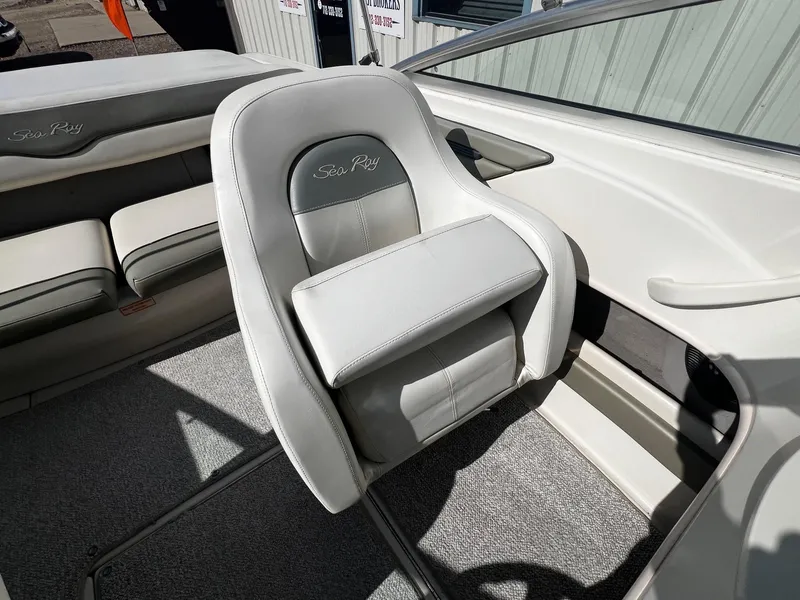 Slide: The Image of 2005 Sea Ray 200 Sport boat interior with white seating and carpet. - 11