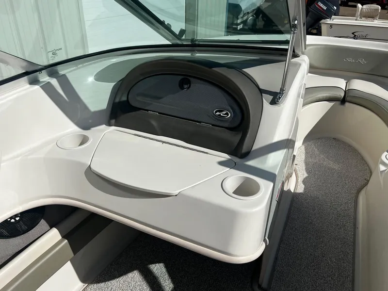 Slide: The Image of 2005 Sea Ray 200 Sport boat interior with dashboard and seating area. - 13