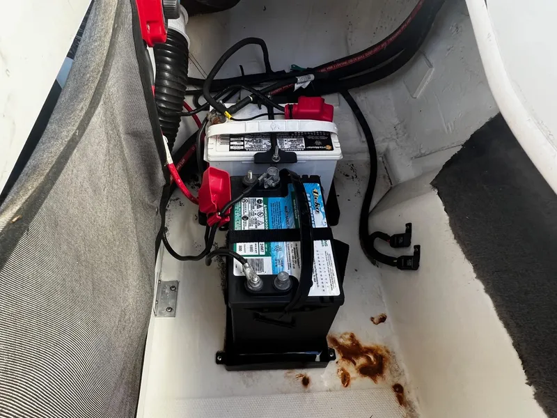 Slide: The Image of 2005 Sea Ray 200 Sport boat battery compartment with dual batteries and wiring. - 16