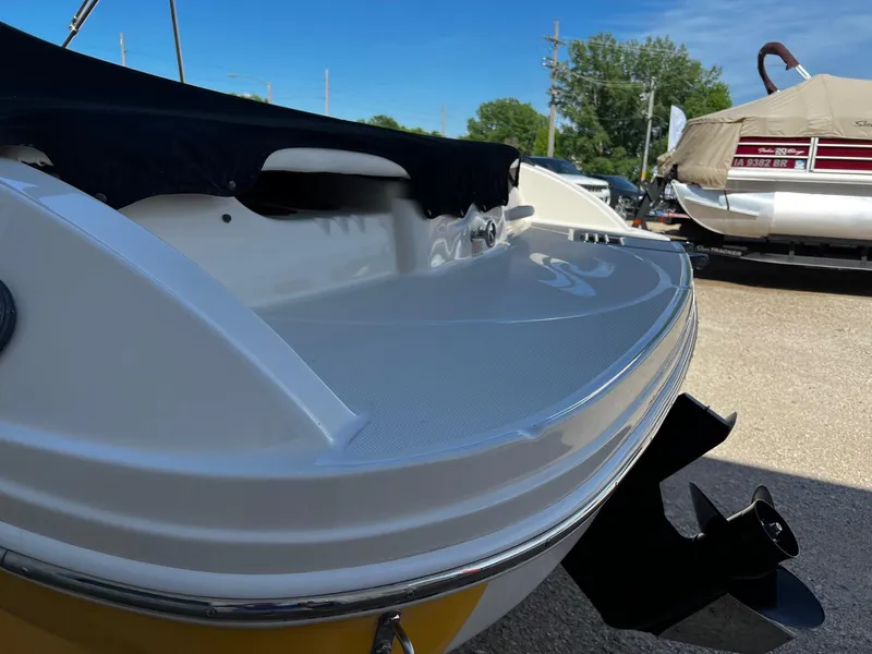 Slide: The Image of 2005 Sea Ray 200 Sport boat rear view with covered seating and outboard motor. - 18