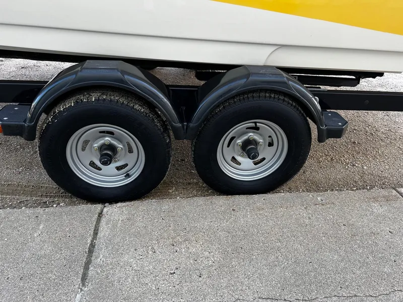 Slide: The Image of Close-up of 2005 Sea Ray 200 Sport trailer wheels on pavement. - 23