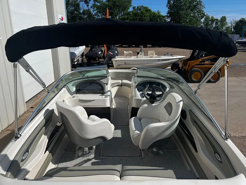 Slide: The Image of 2005 Sea Ray 200 Sport boat interior with seating and steering wheel. - 3