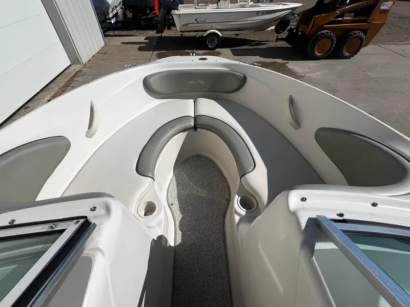 Slide: The Image of 2005 Sea Ray 200 Sport boat interior with cushioned seating and cup holders. - 6
