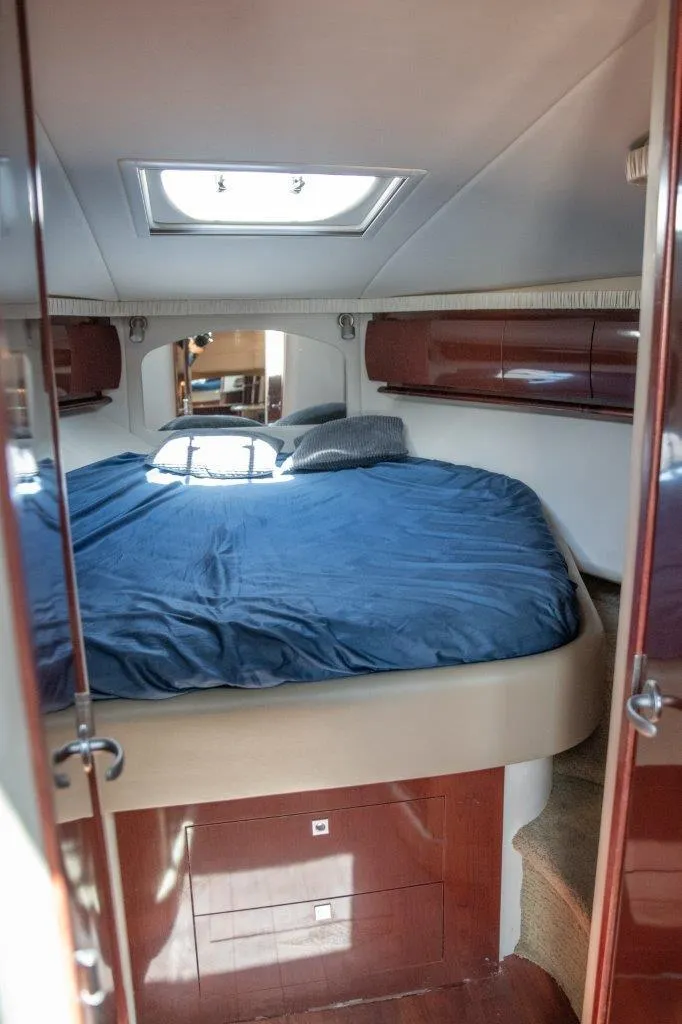 Slide: The Image of Luxurious cabin interior of 2008 Sea Ray 44 Sundancer yacht with skylight and blue bedding. - 14