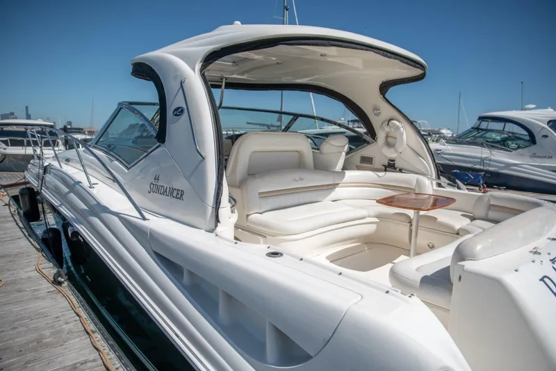 Slide: The Image of 2008 Sea Ray 44 Sundancer yacht with sleek design, docked under clear blue sky. - 17