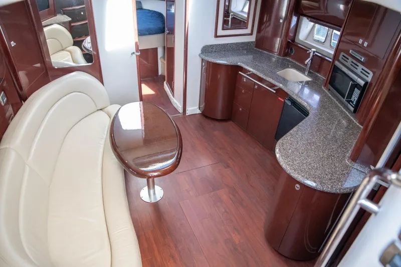 Slide: The Image of Luxurious interior of 2008 Sea Ray 44 Sundancer yacht with elegant seating and modern kitchen. - 8