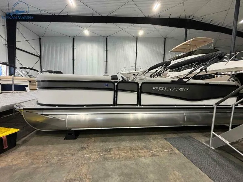 Slide: The Image of 2024 Premier Sunsation 230 RE pontoon boat in indoor showroom. - 1