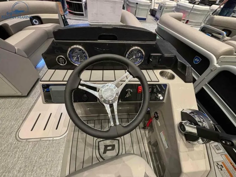 Slide: The Image of 2024 Premier Sunsation 230 RE boat dashboard with steering wheel and control panel. - 12