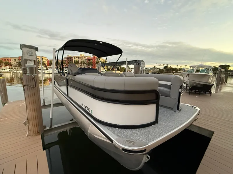 Slide: The Image of 2024 Premier Sunsation 230 RE pontoon boat docked at marina. - 15