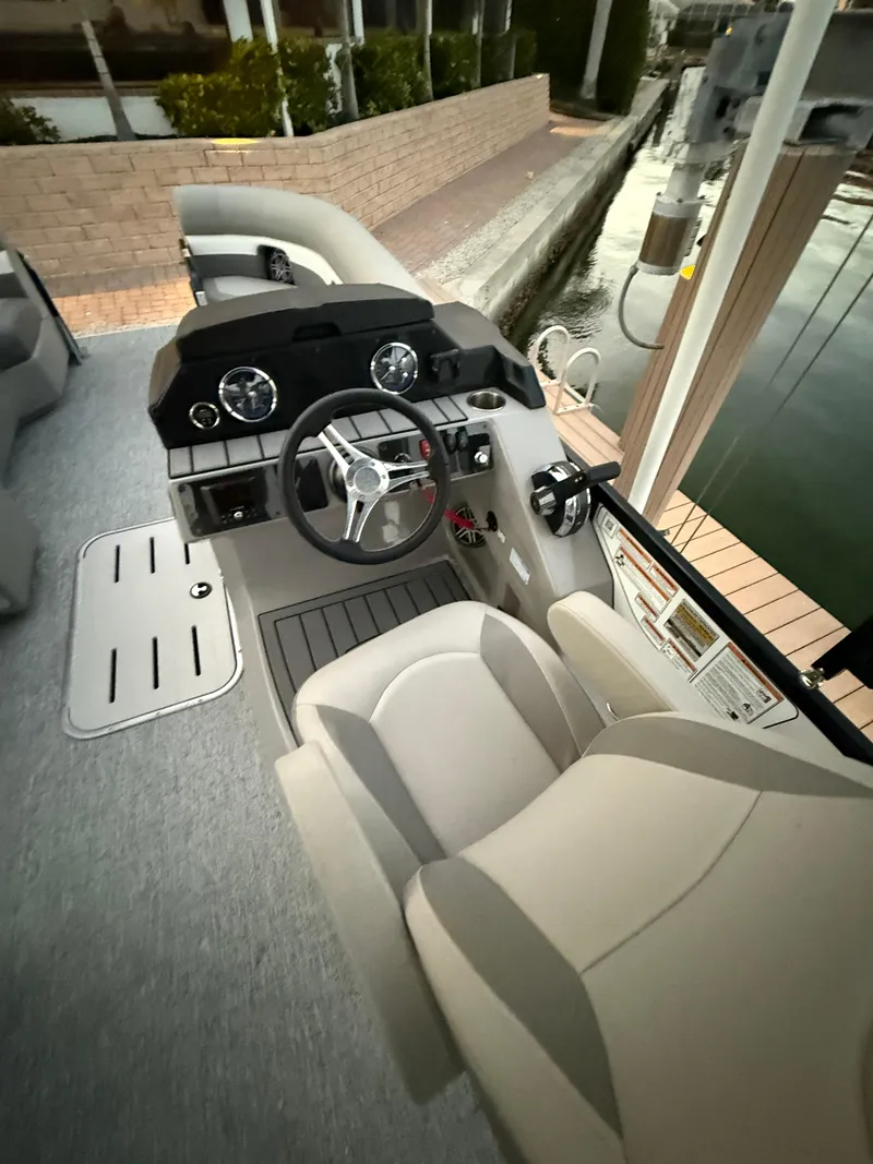 Slide: The Image of 2024 Premier Sunsation 230 RE boat interior with steering wheel and dashboard. - 20