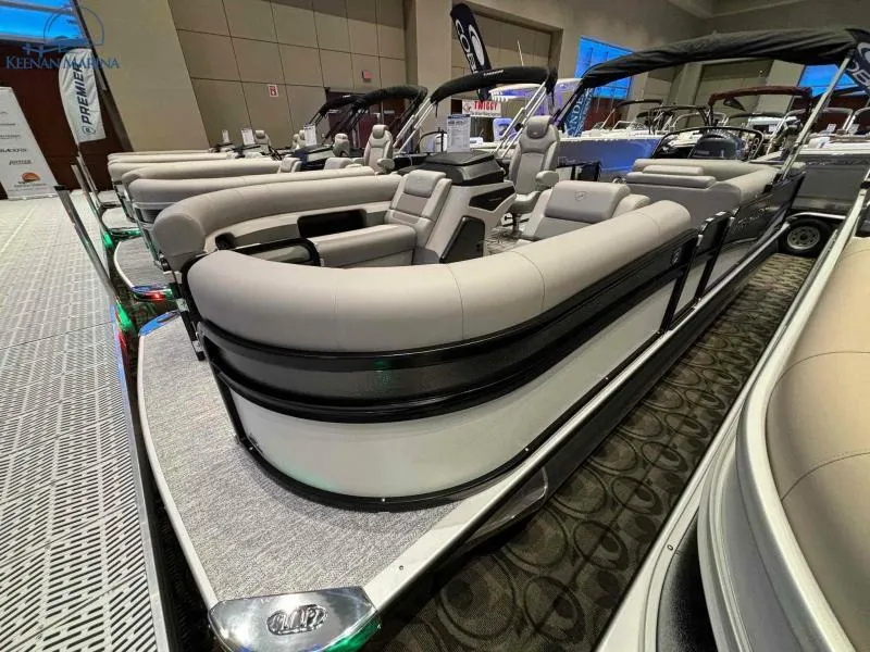 Slide: The Image of 2024 Premier Sunsation 230 RE pontoon boat on display indoors. - 3