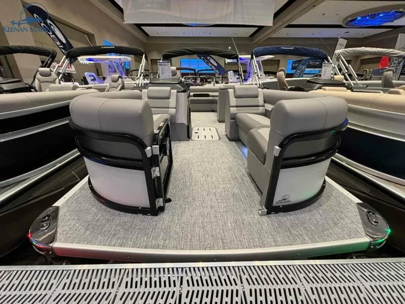Slide: The Image of 2024 Premier Sunsation 230 RE pontoon boat interior at a boat show. - 4