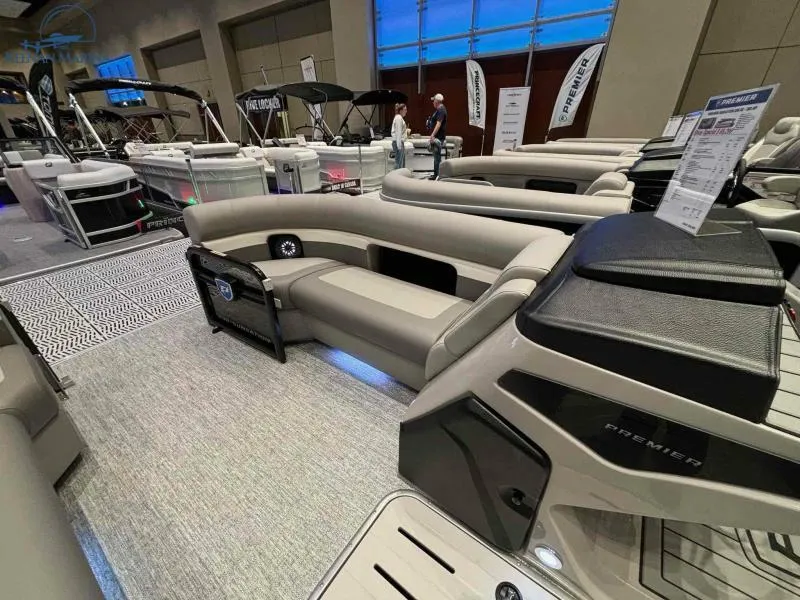 Slide: The Image of 2024 Premier Sunsation 230 RE pontoon boat interior at a boat show. - 7