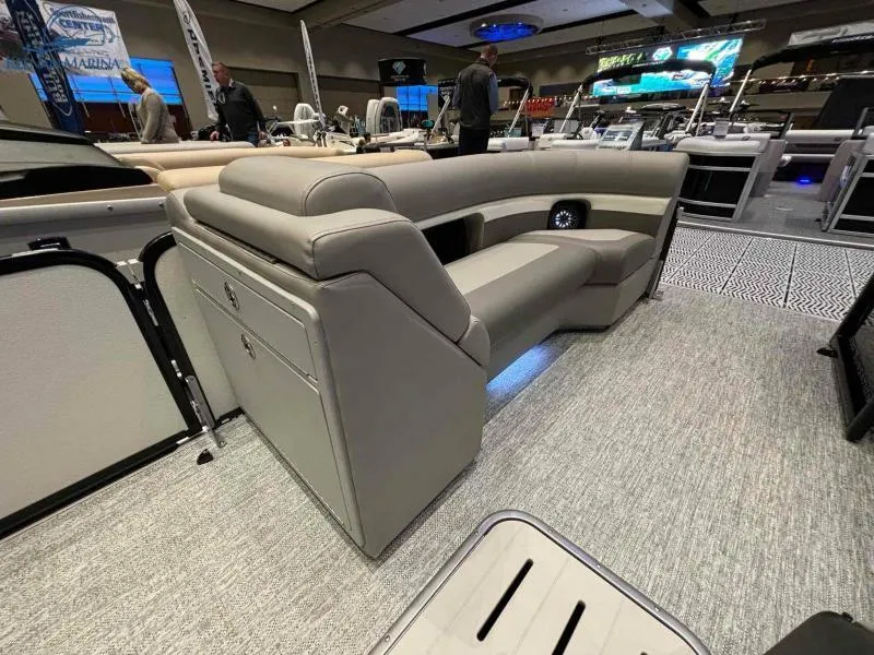 Slide: The Image of 2024 Premier Sunsation 230 RE luxury pontoon boat interior at a boat show. - 8