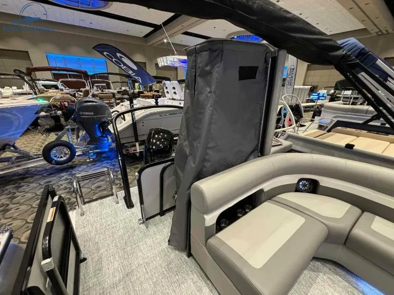 Slide: The Image of 2024 Premier Sunsation 230 RE pontoon boat interior at a showroom display. - 9