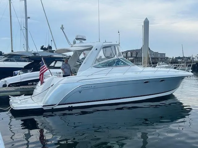 Slide: The Image of 2005 Formula 40 PC yacht docked at marina with American flag. - 16