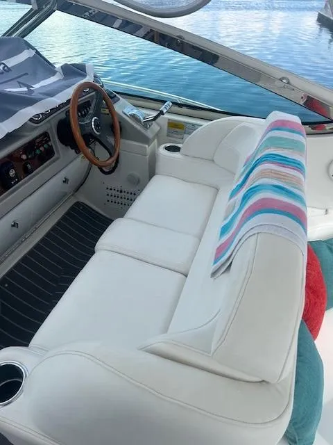 Slide: The Image of 2005 Formula 40 PC boat interior with white seating and colorful towel. - 2