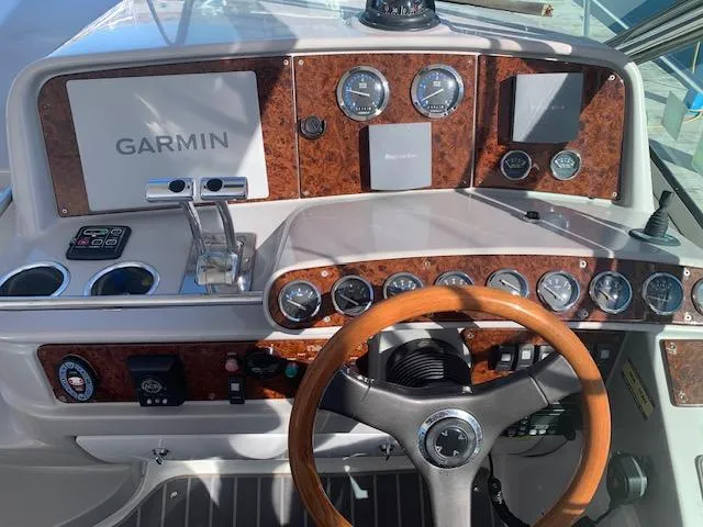 Slide: The Image of 2005 Formula 40 PC boat dashboard with Garmin navigation system and wooden steering wheel. - 3
