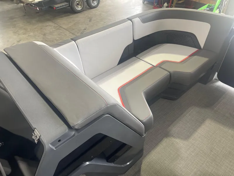 Slide: The Image of 2024 Manitou Cruise boat interior seating with gray and white upholstery. - 11