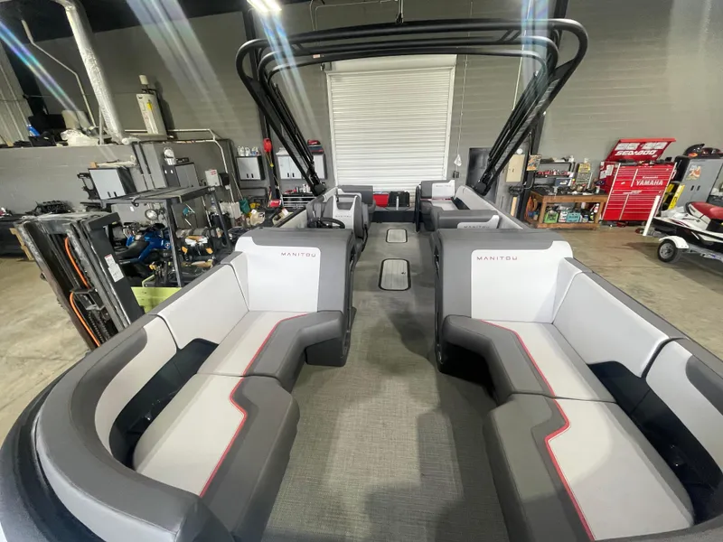 Slide: The Image of 2024 Manitou Cruise boat interior with modern seating in a workshop. - 13