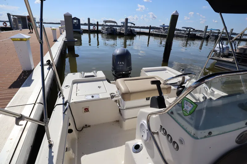Slide: The Image of 2018 Sailfish 1900 BB Bay Boat docked at marina, rear view. - 10