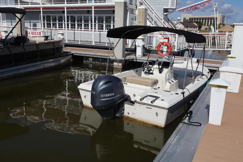 Slide: The Image of 2018 Sailfish 1900 BB Bay Boat docked with Yamaha outboard motor. - 7