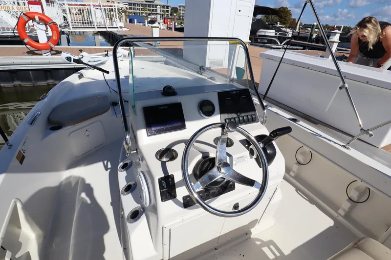 Slide: The Image of 2018 Sailfish 1900 BB Bay Boat dashboard and steering wheel at marina. - 8