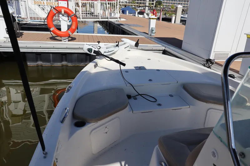 Slide: The Image of 2018 Sailfish 1900 BB Bay Boat docked at marina with seating and storage compartments. - 9