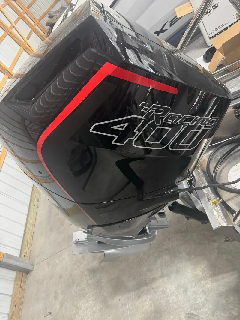 Slide: The Image of 2024 Manitou 25 LX RF with Racing 400 engine in a garage setting. - 12