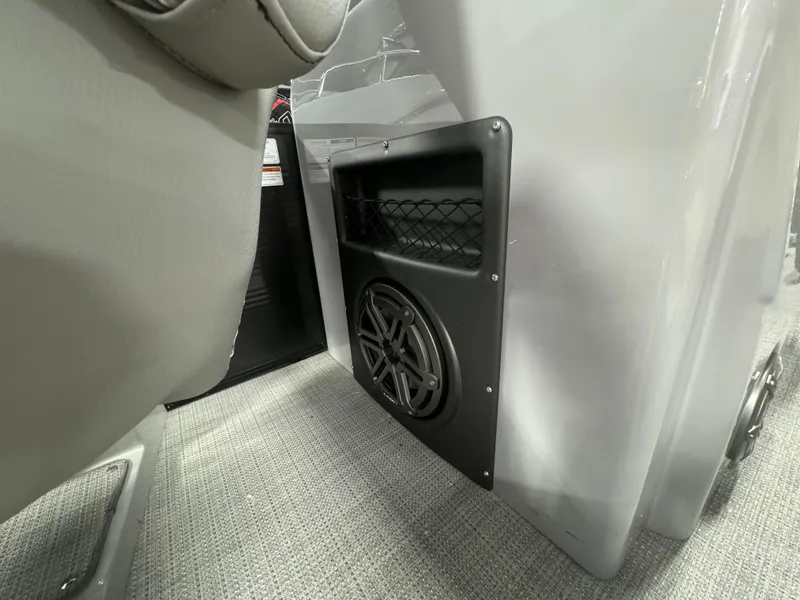 Slide: The Image of 2024 Manitou 25 LX RF interior speaker and storage compartment detail. - 16