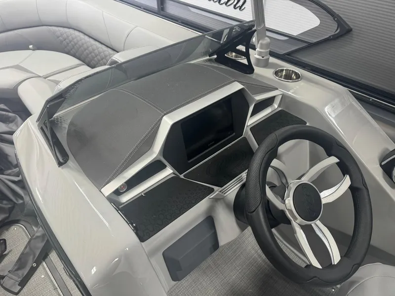 Slide: The Image of 2024 Manitou 25 LX RF boat dashboard with modern steering wheel and digital display. - 5
