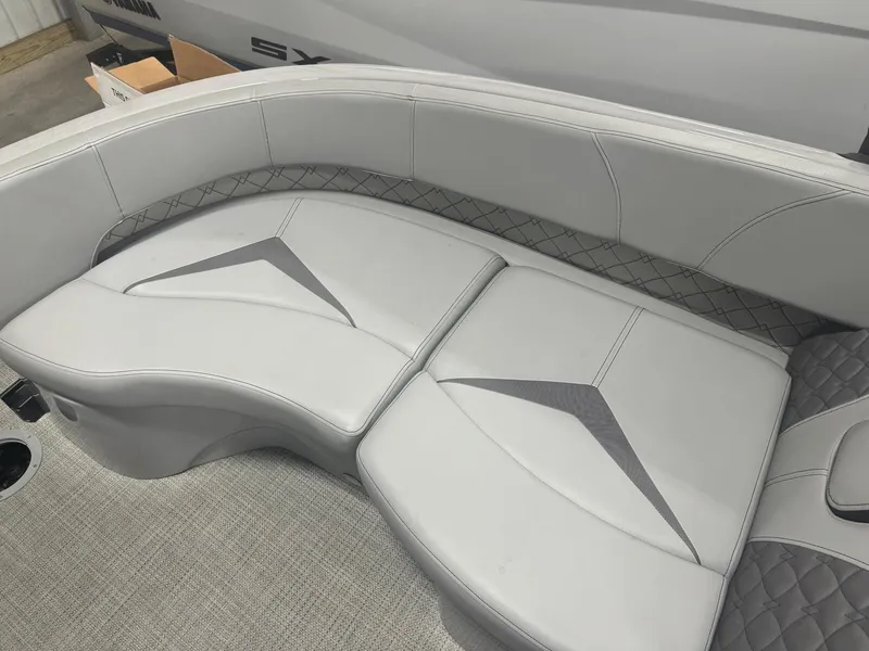 Slide: The Image of 2024 Manitou 25 LX RF boat interior with sleek, modern seating design. - 6