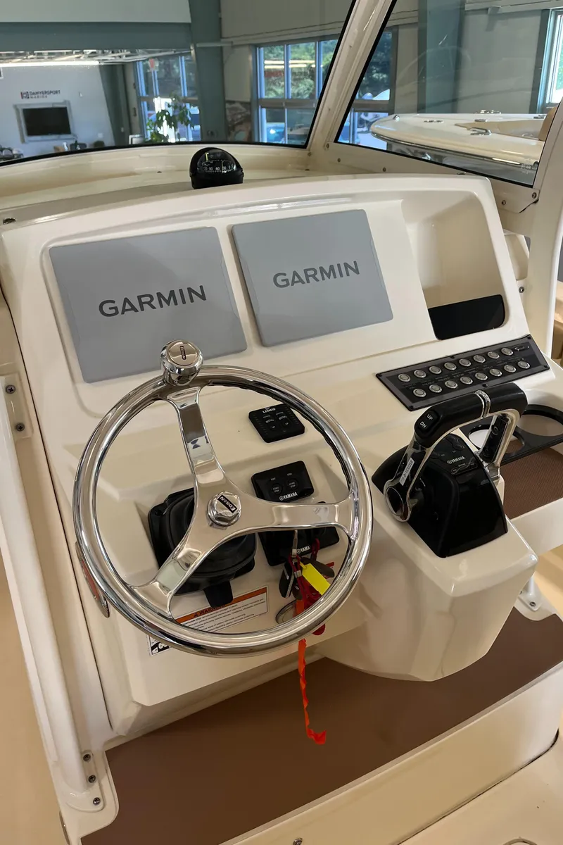 Slide: The Image of 2020 Scout 255 LXF boat dashboard with Garmin navigation system and steering wheel. - 11