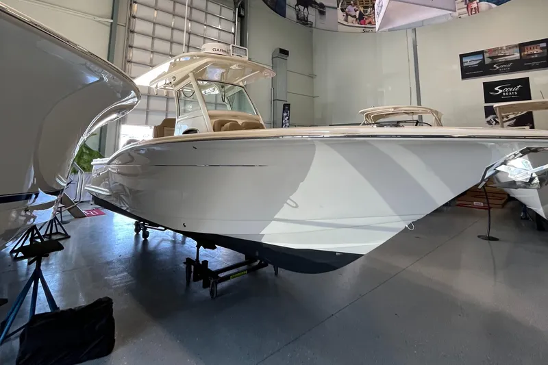 Slide: The Image of 2020 Scout 255 LXF boat displayed in a showroom. - 2