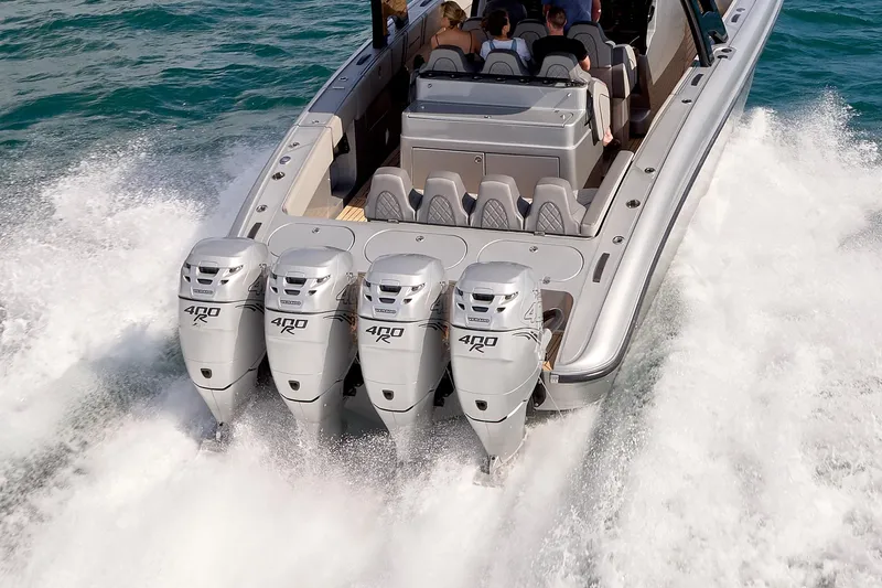 Slide: The Image of 2018 Midnight Express 43 Open boat with four powerful outboard engines cruising on water. - 13