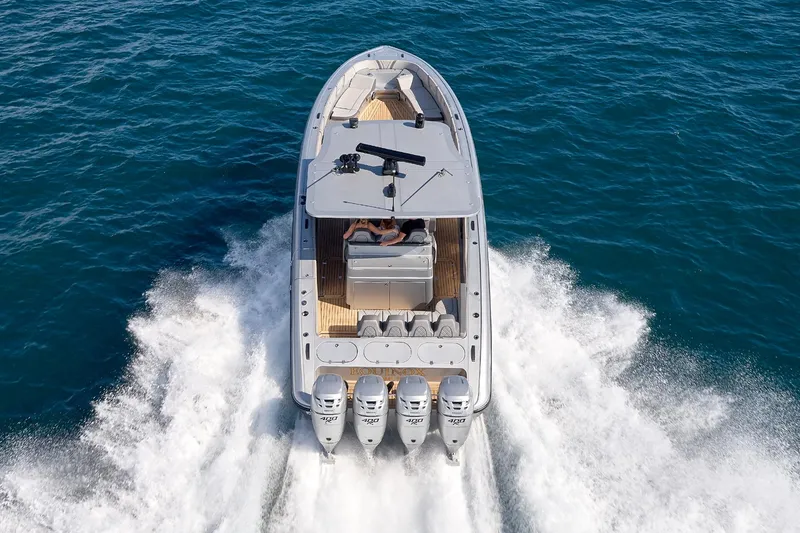 Slide: The Image of 2018 Midnight Express 43 Open boat cruising on open water, rear view. - 25