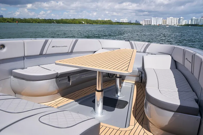 Slide: The Image of 2018 Midnight Express 43 Open boat with sleek seating and table on deck. - 34