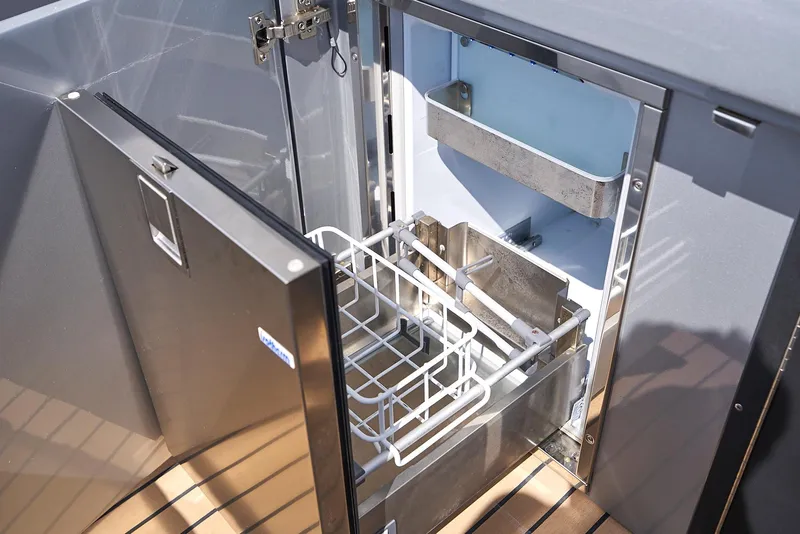 Slide: The Image of Open refrigerator on 2018 Midnight Express 43 Open boat, featuring stainless steel interior and wooden flooring. - 39