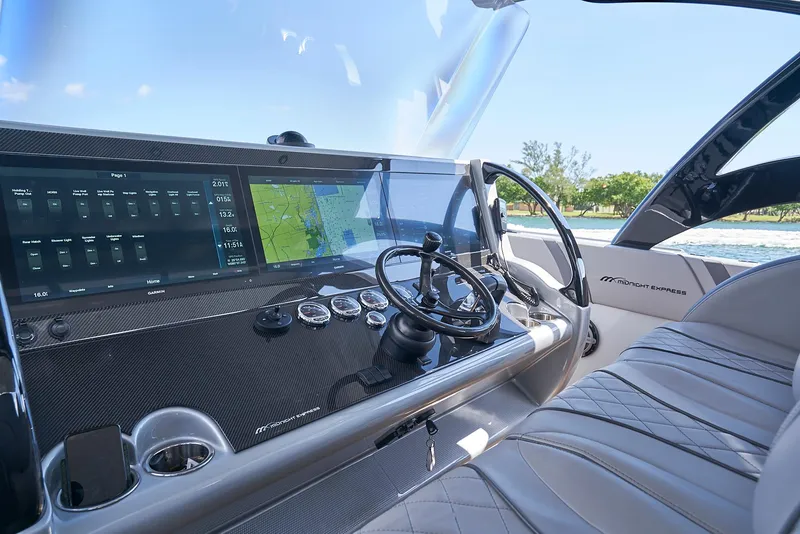 Slide: The Image of Cockpit of 2018 Midnight Express 43 Open boat with advanced navigation system. - 43