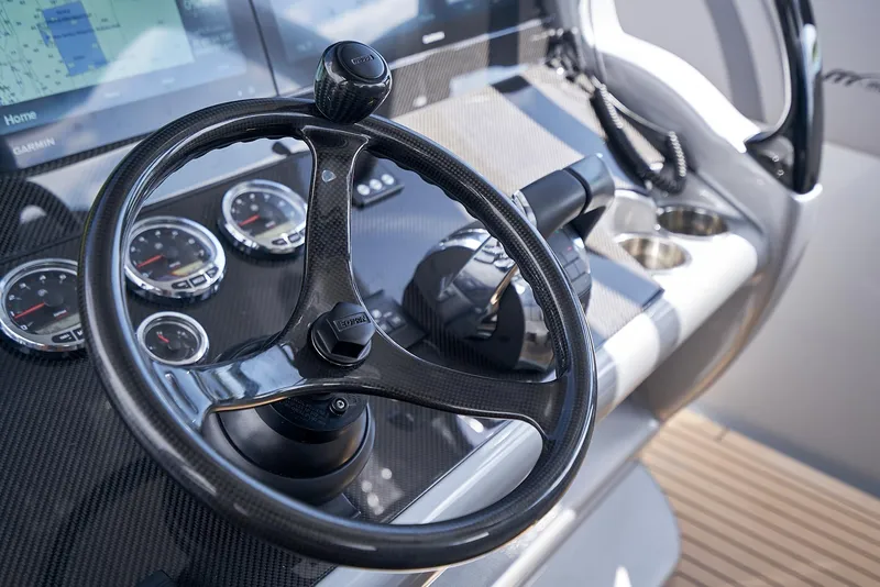 Slide: The Image of Steering wheel and dashboard of 2018 Midnight Express 43 Open boat. - 48