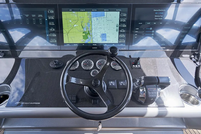 Slide: The Image of 2018 Midnight Express 43 Open helm with navigation screens and controls. - 49