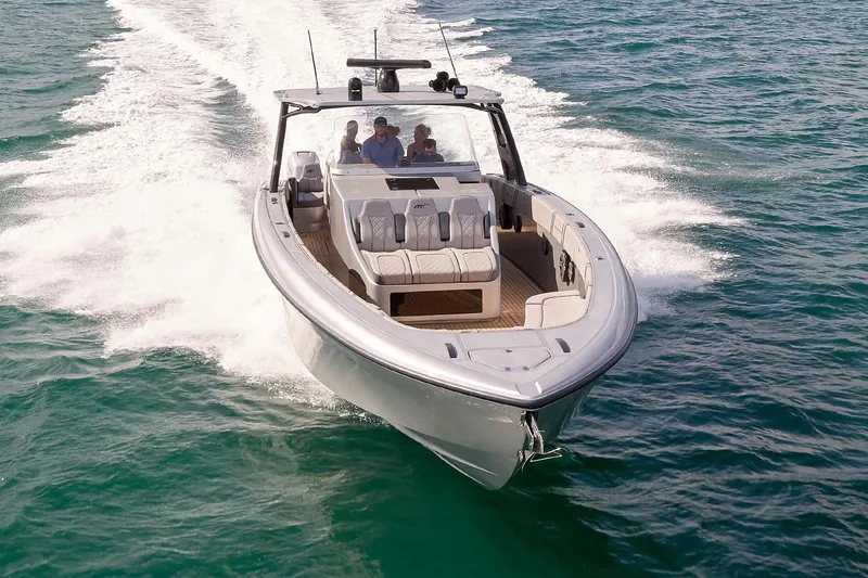 The Image of 2018 Midnight Express 43 Open boat cruising on clear blue water. - 5