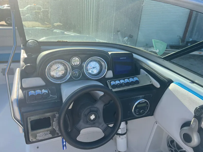 Slide: The Image of 2018 Crownline Eclipse E21 XS boat dashboard with steering wheel and gauges. - 12
